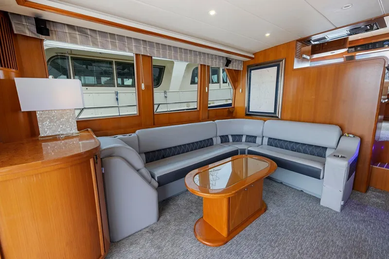 Slide: The Image of Luxurious 2002 Symbol 58 yacht interior with elegant seating and wooden accents. - 9