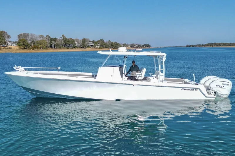 Slide: The Image of 2024 Contender 39 ST boat on calm water, featuring sleek design and powerful engines. - 13