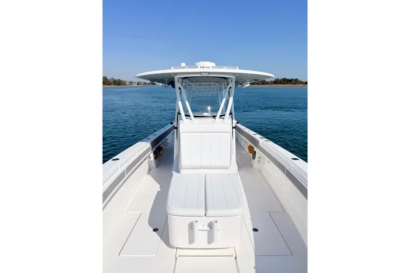 Slide: The Image of 2024 Contender 39 ST boat on calm water, showcasing sleek design and spacious deck. - 17