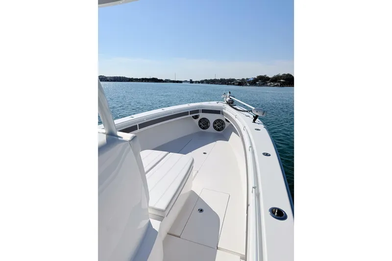 Slide: The Image of 2024 Contender 39 ST boat on calm water, showcasing sleek design and spacious deck. - 18