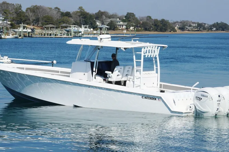 Slide: The Image of 2024 Contender 39 ST boat on calm water with Yamaha engines. - 5