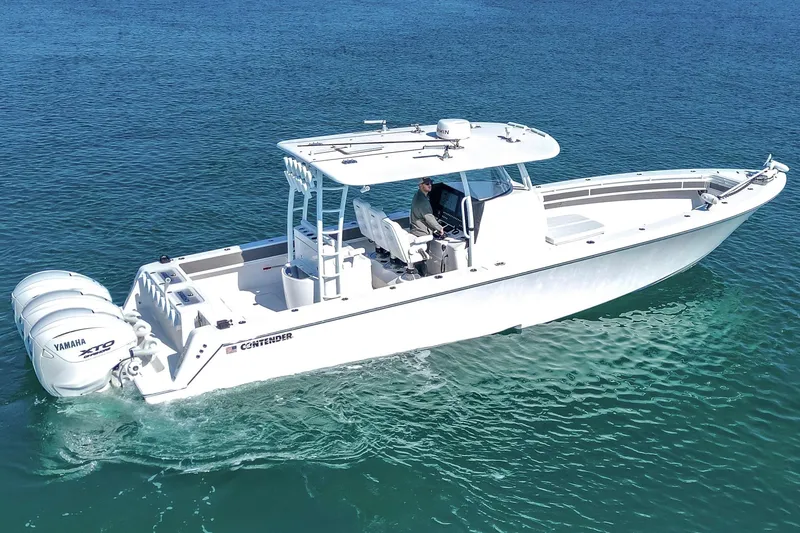 Slide: The Image of 2024 Contender 39 ST boat cruising on clear blue water, featuring Yamaha engines. - 6
