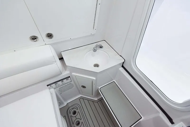 Slide: The Image of Manufacturer Provided Image: 2024 Sportsman Open 302 Center Console boat interior with sink and storage. - 32