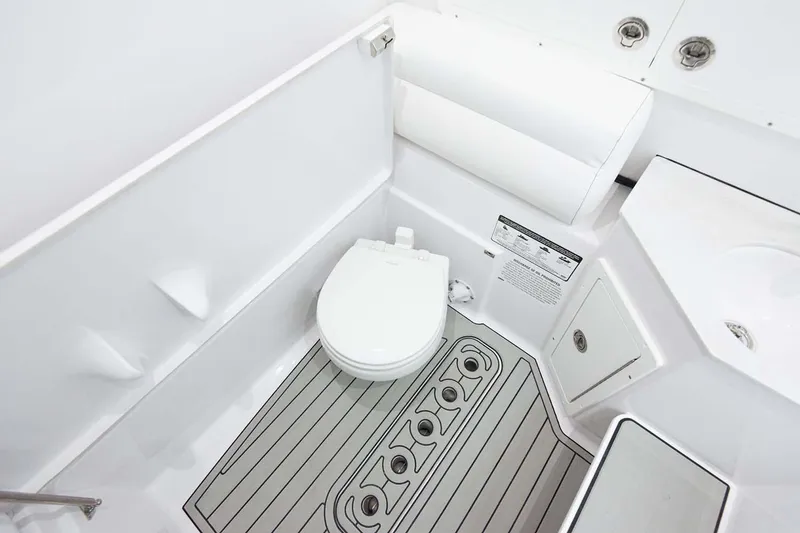 Slide: The Image of Manufacturer Provided Image: 2024 Sportsman Open 302 Center Console boat bathroom with toilet and sink. - 33