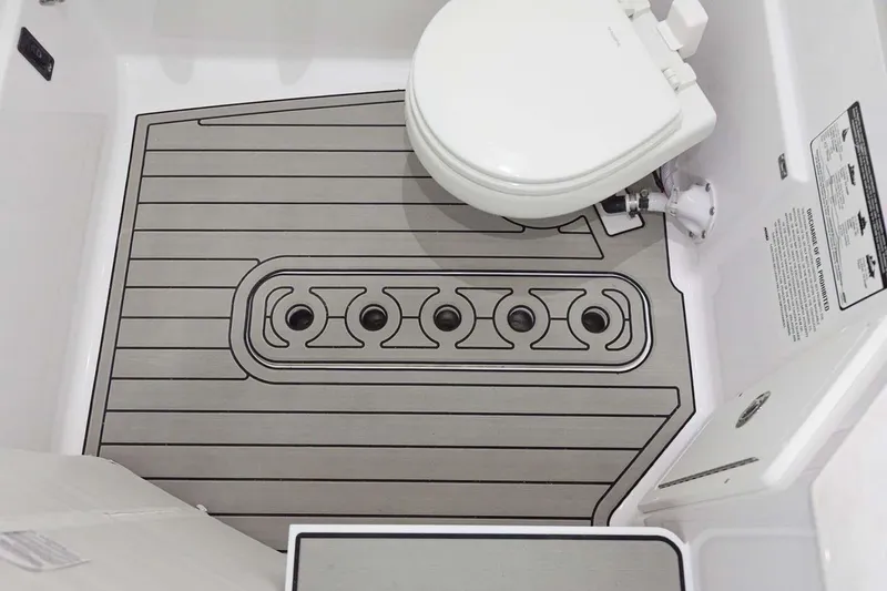 Slide: The Image of Manufacturer Provided Image: 2024 Sportsman Open 302 Center Console boat bathroom with toilet and non-slip flooring. - 34