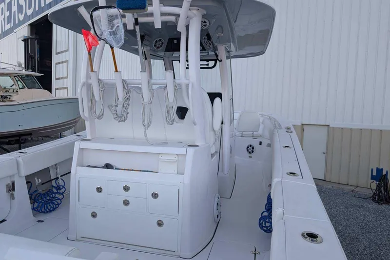 Slide: The Image of 2024 Sportsman Open 302 Center Console boat with fishing gear and storage compartments. - 35