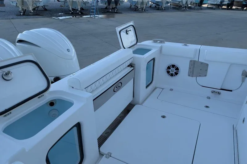 Slide: The Image of 2024 Sportsman Open 302 Center Console boat interior with storage compartments and seating. - 39