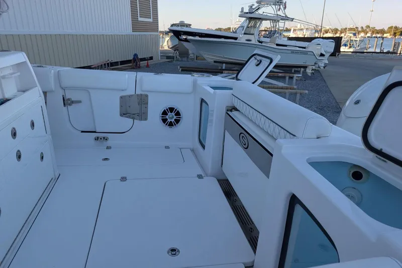 Slide: The Image of 2024 Sportsman Open 302 Center Console boat interior with seating and storage. - 43