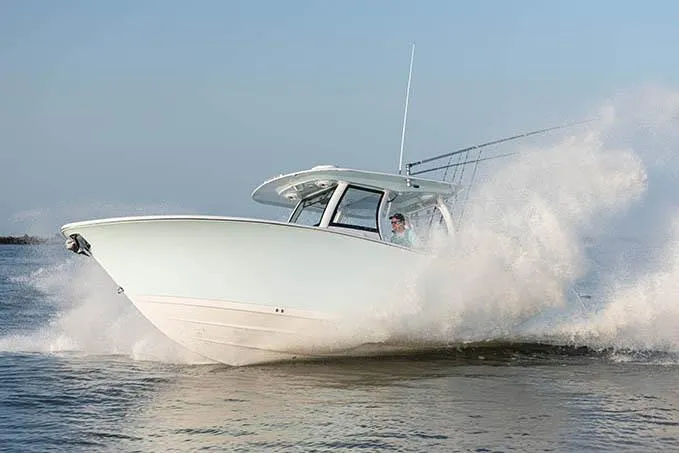 Slide: The Image of Manufacturer Provided Image: 2024 Sportsman Open 302 Center Console boat cruising on water. - 5
