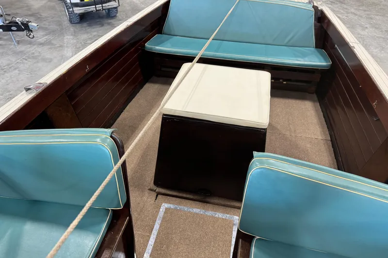 Slide: The Image of 1959 Chris-Craft 22 Sea Skiff interior with blue seating and wooden finish. - 11