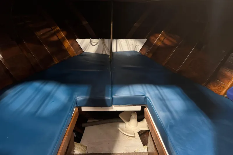 Slide: The Image of 1959 Chris-Craft 22 Sea Skiff interior with blue cushions and wooden paneling. - 12