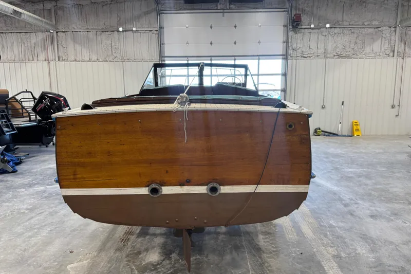 Slide: The Image of 1959 Chris-Craft 22 Sea Skiff in a garage, showcasing its wooden hull. - 5