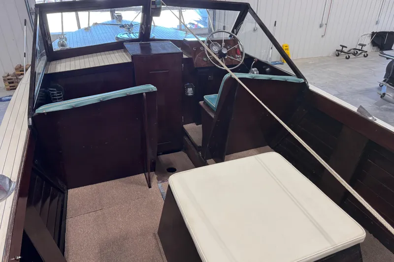 Slide: The Image of 1959 Chris-Craft 22 Sea Skiff interior with vintage steering wheel and seating. - 7