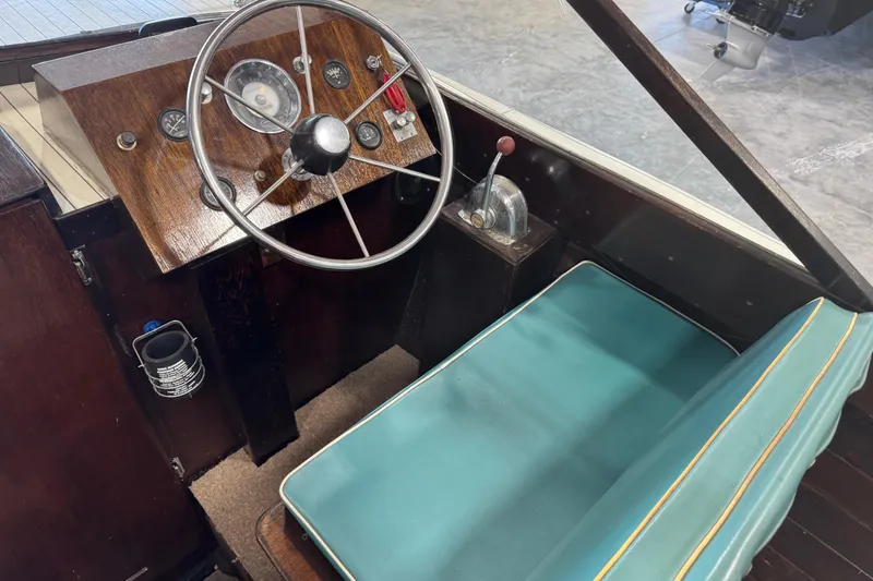 Slide: The Image of 1959 Chris-Craft 22 Sea Skiff interior with vintage steering wheel and teal seat. - 9