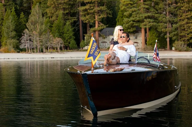 Slide: The Image of Couple relaxing on a 2007 Hacker-Craft 32 Sportabout boat on a serene lake. - 11