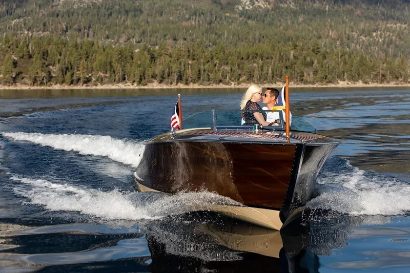 Slide: The Image of 2007 Hacker-Craft 32 Sportabout cruising on a scenic lake with a couple onboard. - 13