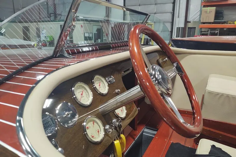 Slide: The Image of Interior of a 2007 Hacker-Craft 32 Sportabout with wooden steering wheel and classic gauges. - 15
