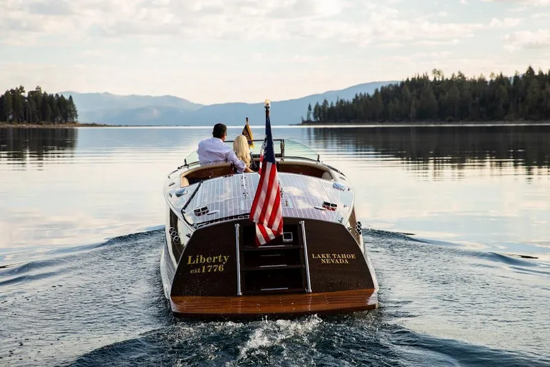 Slide: The Image of 2007 Hacker-Craft 32 Sportabout cruising on Lake Tahoe, Nevada, with American flag. - 2