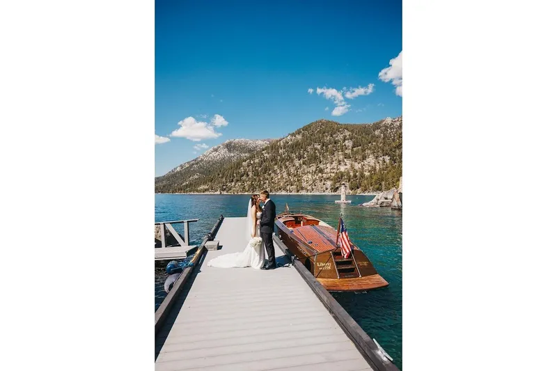 Slide: The Image of Bride and groom on dock with 2007 Hacker-Craft 32 Sportabout boat, scenic lake and mountains. - 22