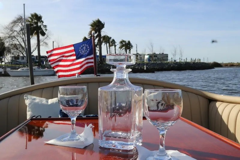 Slide: The Image of 2007 Hacker-Craft 32 Sportabout with glassware and American flag on a sunny day. - 23