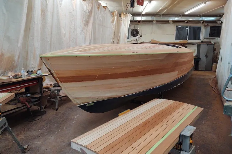 Slide: The Image of 2007 Hacker-Craft 32 Sportabout boat under construction in a workshop. - 33