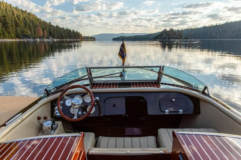 Slide: The Image of 2007 Hacker-Craft 32 Sportabout on serene lake with scenic forested shoreline. - 6