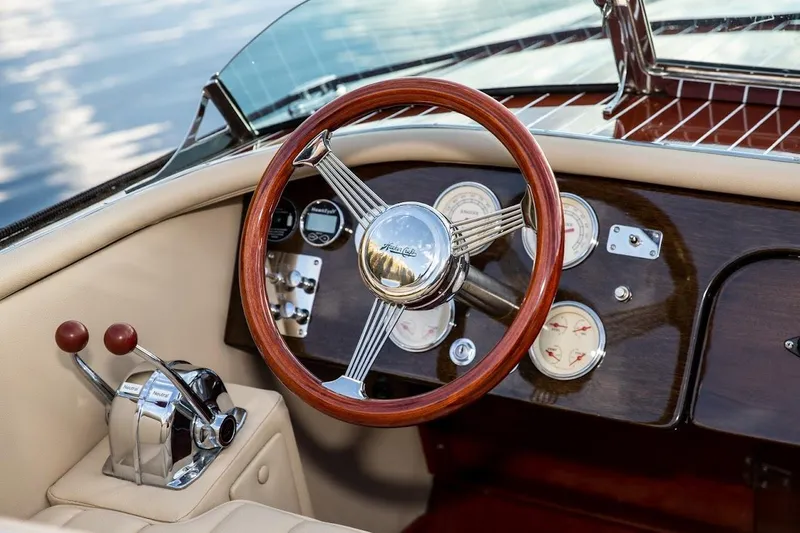 Slide: The Image of Steering wheel and dashboard of 2007 Hacker-Craft 32 Sportabout boat, featuring classic wood design. - 9