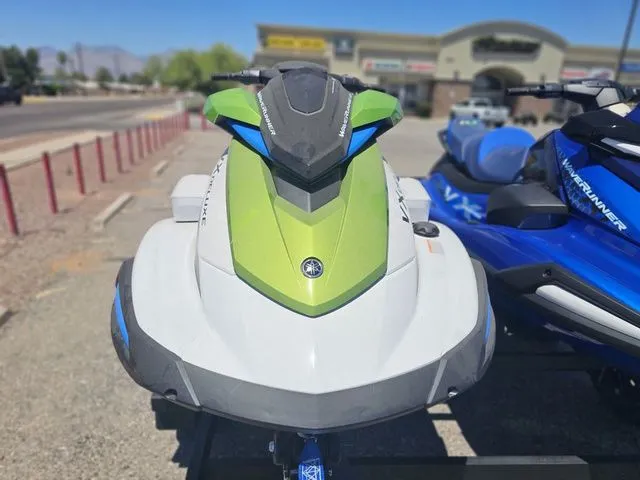 Slide: The Image of 2026 Yamaha WaveRunner VX in green and blue on parking lot. - 2