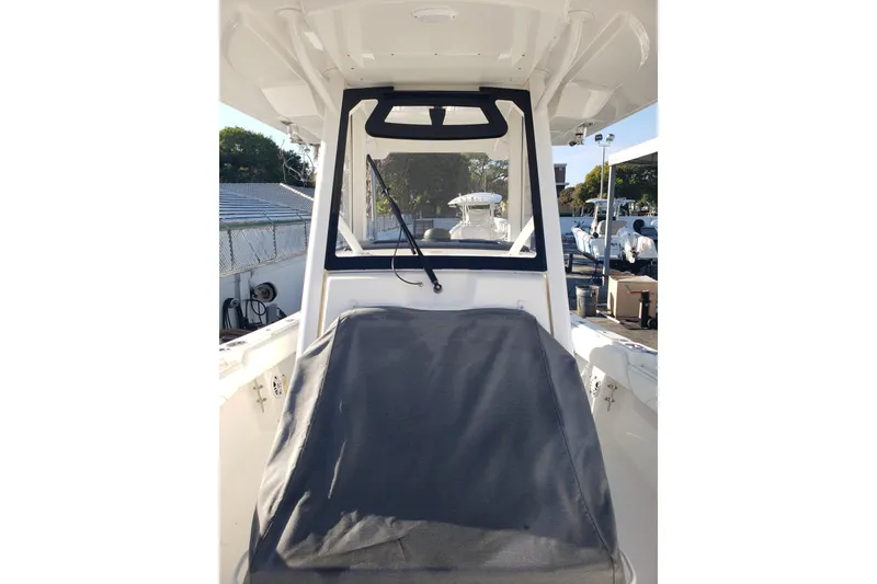 Slide: The Image of 2022 Regulator 31 boat interior with covered seating and windshield view. - 10