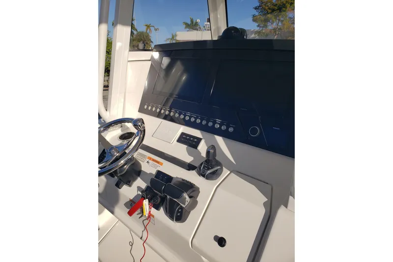 Slide: The Image of 2022 Regulator 31 boat dashboard with steering wheel and control panel. - 12