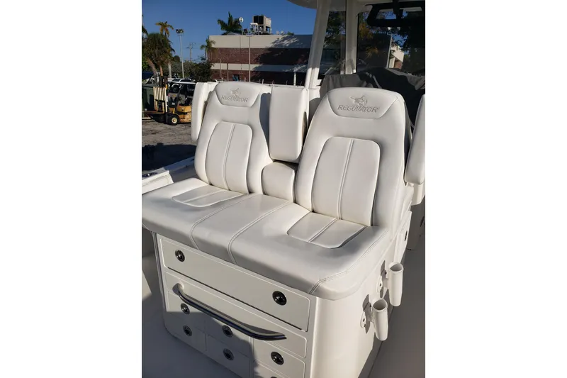 Slide: The Image of Luxurious white seating on 2022 Regulator 31 boat, featuring sleek design and storage. - 13