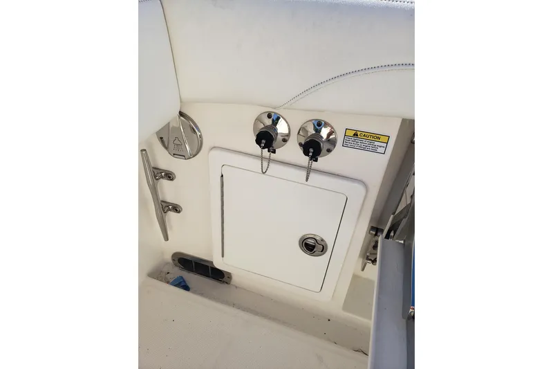 Slide: The Image of 2022 Regulator 31 boat interior with access panel and control switches. - 16