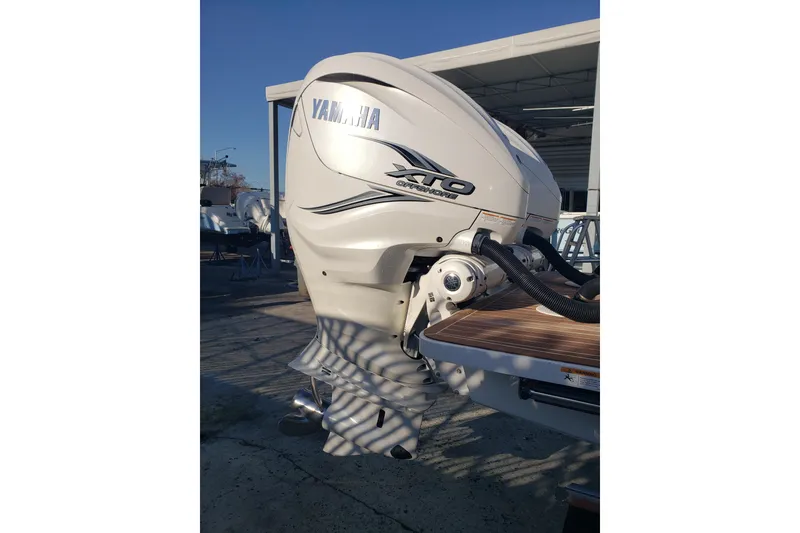 Slide: The Image of 2022 Regulator 31 boat with Yamaha XTO outboard engine in a marina setting. - 20