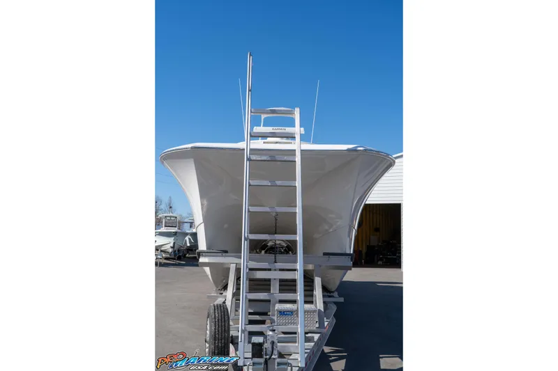 Slide: The Image of Front view of 2026 Front Runner 43 Catamaran on trailer under clear blue sky. - 12