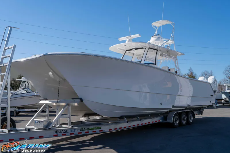 Slide: The Image of 2026 Front Runner 43 Catamaran on trailer, displayed outdoors under clear blue sky. - 2