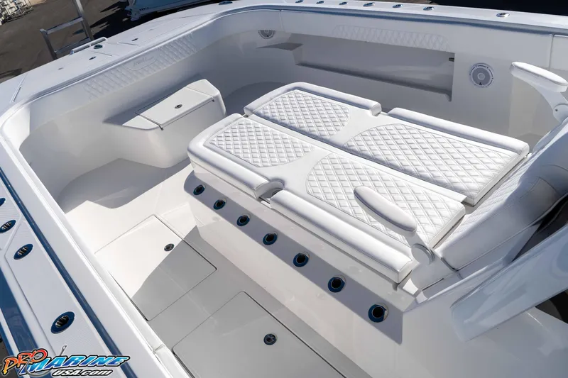 Slide: The Image of 2026 Front Runner 43 Catamaran interior with white cushioned seating and storage compartments. - 20