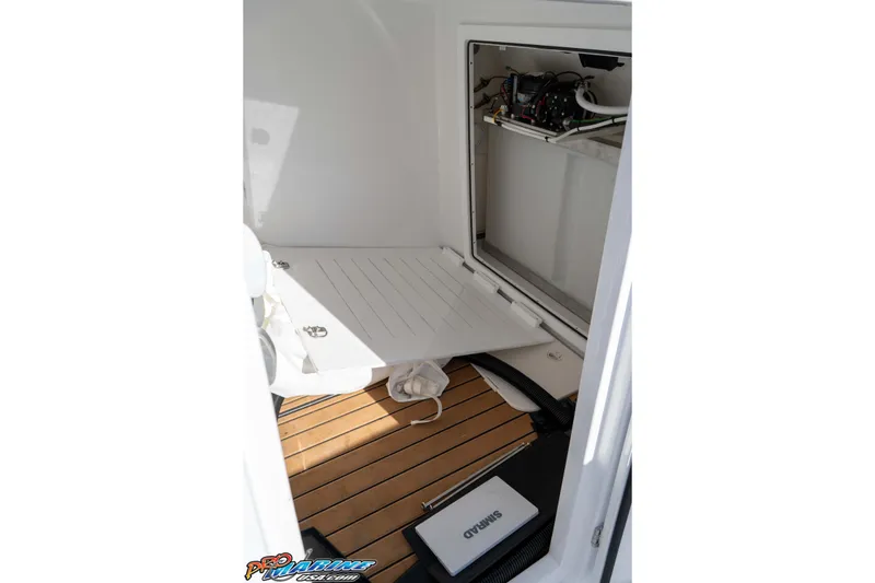 Slide: The Image of Interior view of 2026 Front Runner 43 Catamaran with open storage compartment and teak flooring. - 24