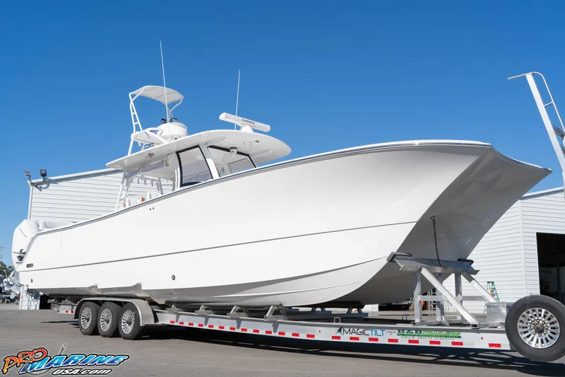 Slide: The Image of 2026 Front Runner 43 Catamaran on trailer, displayed outdoors under clear blue sky. - 7
