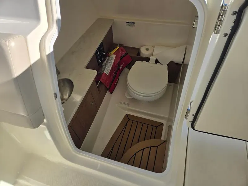 Slide: The Image of Interior of 2018 Boston Whaler 270 Vantage with toilet and sink. - 16