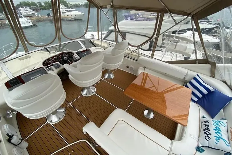 Slide: The Image of Interior of 2000 Sea Ray 400 Sedan Bridge yacht with helm and seating area. - 10