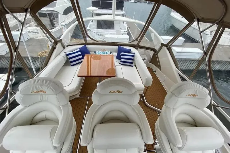 Slide: The Image of Luxurious interior of a 2000 Sea Ray 400 Sedan Bridge yacht with plush seating and table. - 11