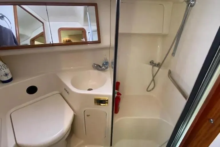 Slide: The Image of Bathroom interior of 2000 Sea Ray 400 Sedan Bridge yacht, featuring shower and sink. - 12