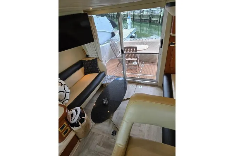 Slide: The Image of Interior of 2000 Sea Ray 400 Sedan Bridge yacht with modern seating and deck view. - 6