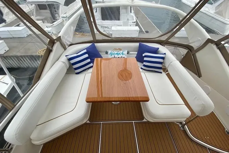 Slide: The Image of Luxurious seating area on 2000 Sea Ray 400 Sedan Bridge yacht with striped cushions. - 7
