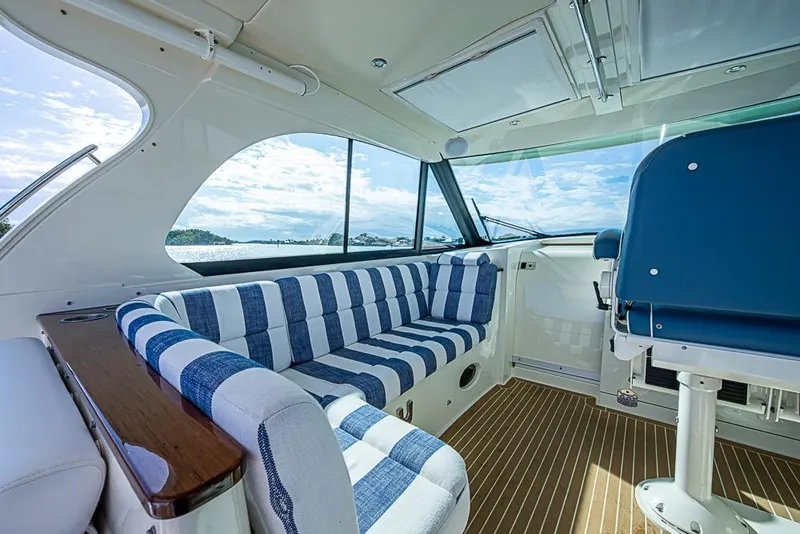 Slide: The Image of Interior of 2023 Hinckley Sport Boat 40 X with striped seating and scenic view. - 15