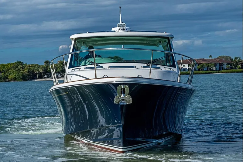 Slide: The Image of 2023 Hinckley Sport Boat 40 X cruising on a scenic waterway. - 2