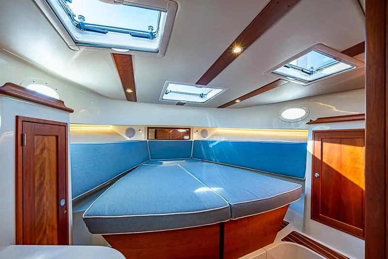 Slide: The Image of Interior of 2023 Hinckley Sport Boat 40 X, featuring a cozy cabin with skylights. - 28