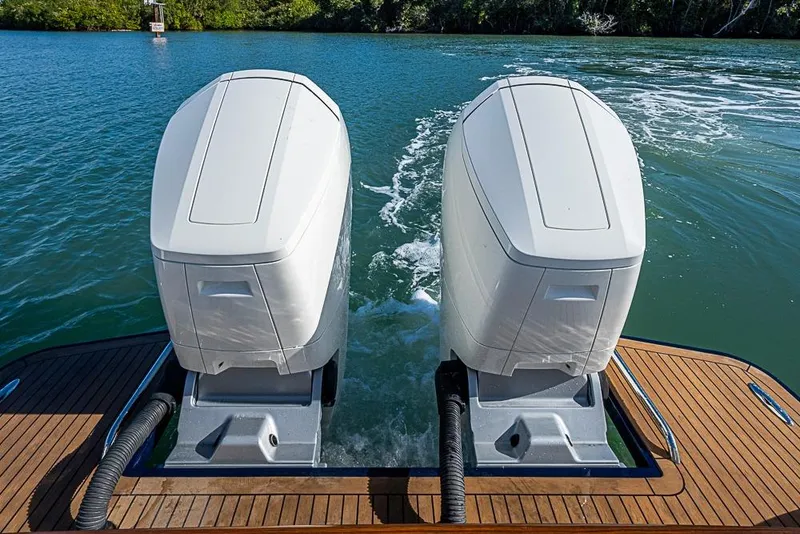 Slide: The Image of 2023 Hinckley Sport Boat 40 X with dual outboard engines on water. - 33