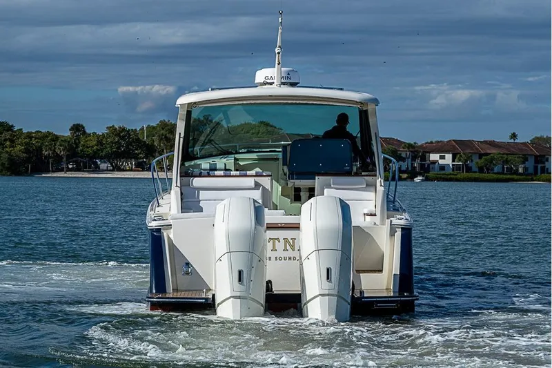 Slide: The Image of 2023 Hinckley Sport Boat 40 X cruising on a serene waterway. - 4
