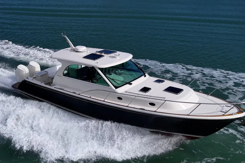 Slide: The Image of 2023 Hinckley Sport Boat 40 X cruising on open water, showcasing sleek design and powerful engines. - 40